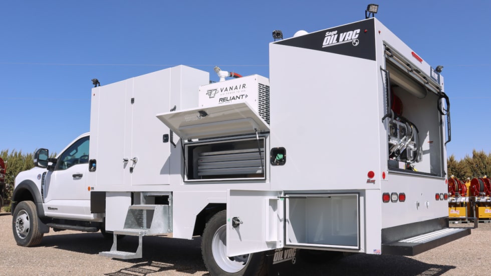 Rear-quarter view of a white work truck with storage doors open.