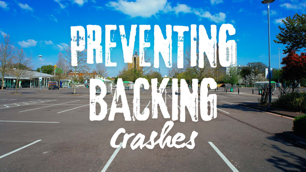 Empty parking lot representing common locations for backing accidents and the need for driver awareness and caution when reversing vehicles.