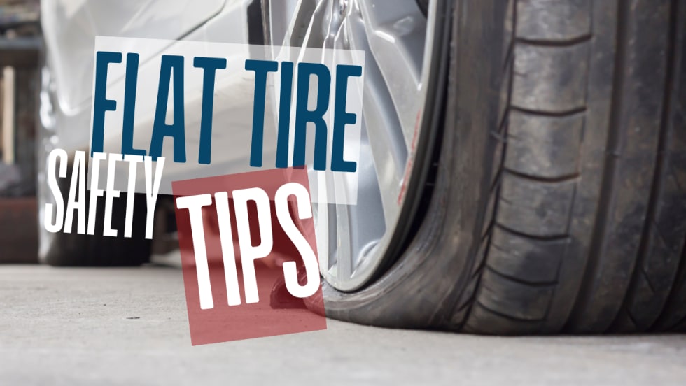 Close-up of a flat car tire on the roadside, illustrating the importance of safe handling and proper response during a tire emergency.