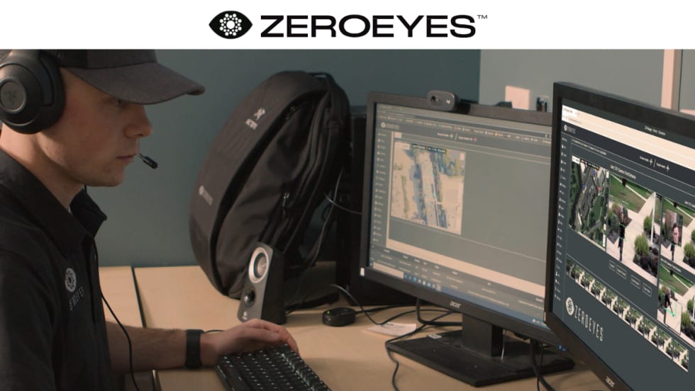 Security worker watching computer monitors, with a white area at top with a logo for ZeroEyes.