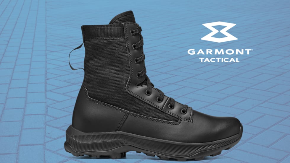 Black military style leather boot against a blue cobblestone background with a white Garmont Tactical logo.