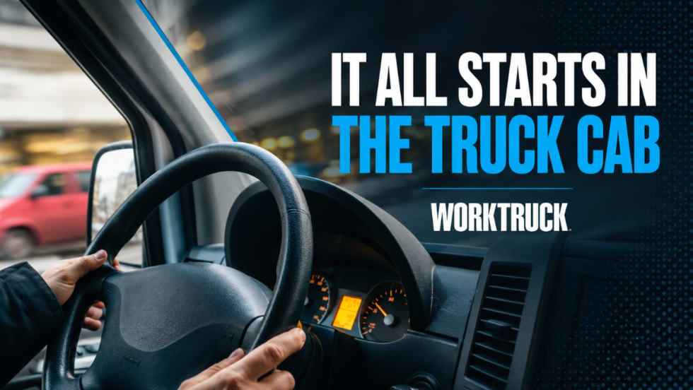 View from inside a work truck cab showing a driver’s hands on the steering wheel while traveling through an urban area. The image includes the headline “It All Starts in the Truck Cab” and illustrates how driver behavior influences fuel consumption, operating costs, and fleet performance.