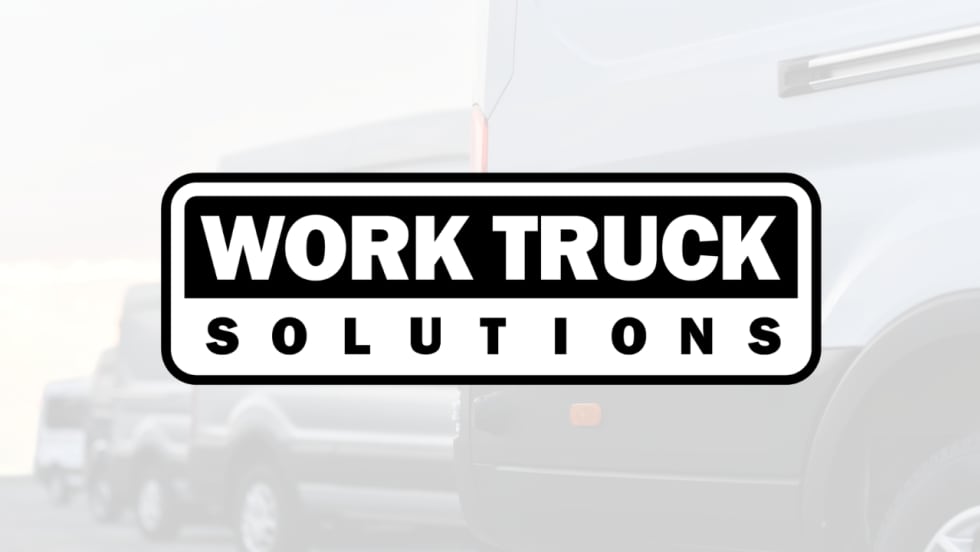 Work Truck Solutions logo centered over a faded background featuring commercial work trucks.
