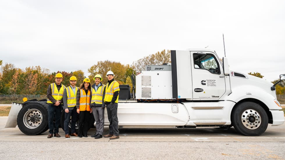 Group of researchers and engineers standing next to an electric heavy-duty truck used in Purdue’s wireless charging project.