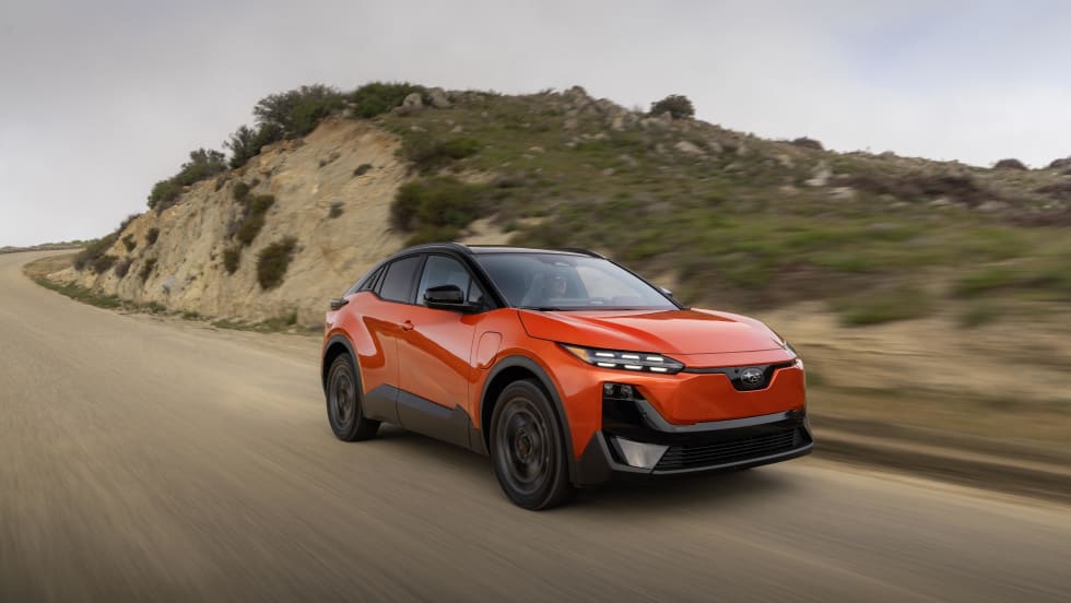 A 2027 red subaru uncharted drives down a road