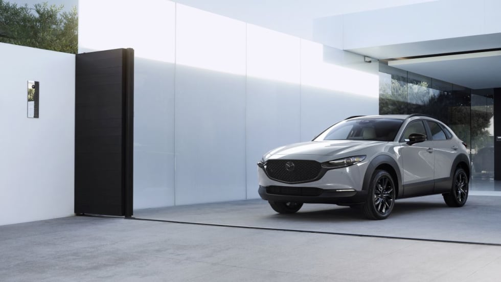 2026 Mazda CX-30 compact SUV parked in front of a modern home, showcasing updated styling and design.