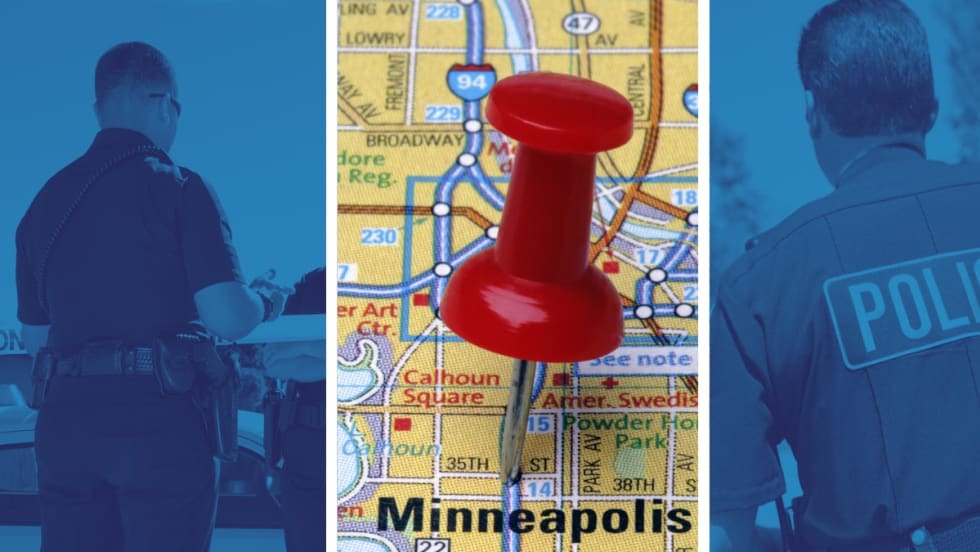 Red pushpin marking Minneapolis city map with police officers in background