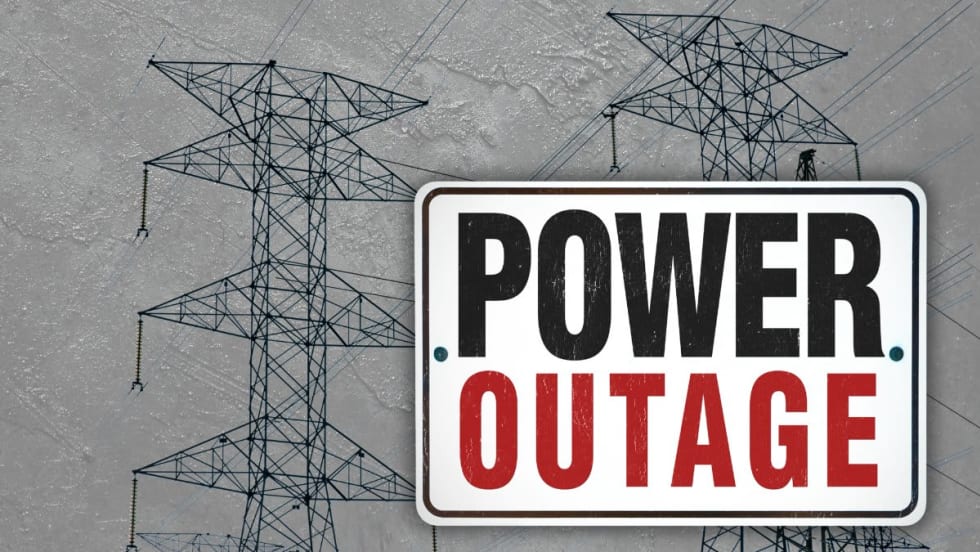 Power lines on a stormy day with the words POWER OUTAGE