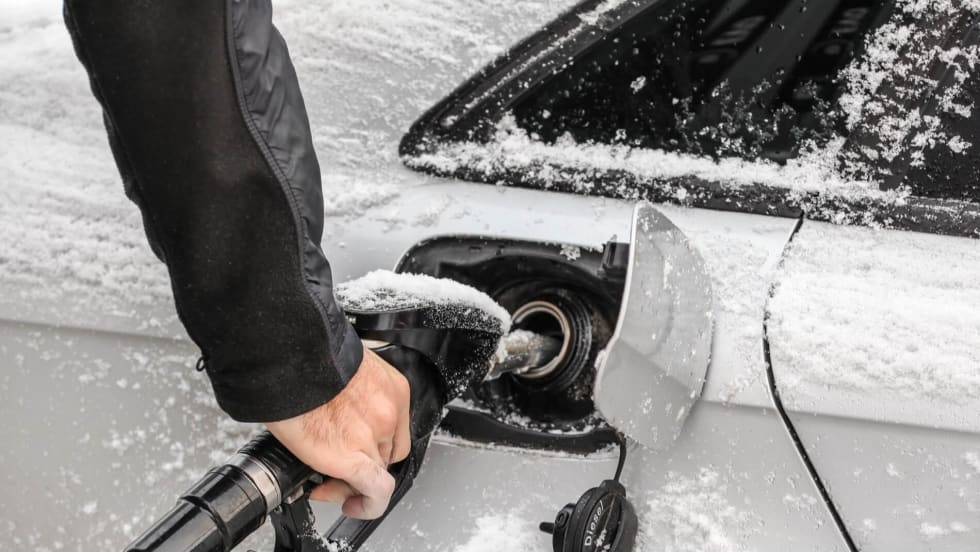Fuel getting pump into a white car