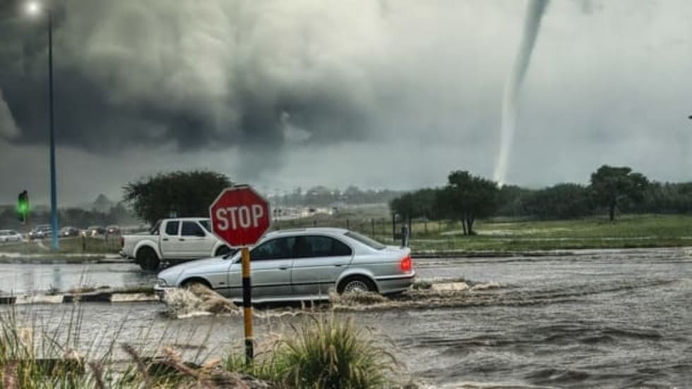 Cars through a flooding street