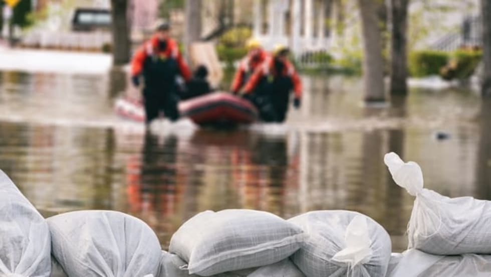 Rescuers dragging a boat duing a flood
