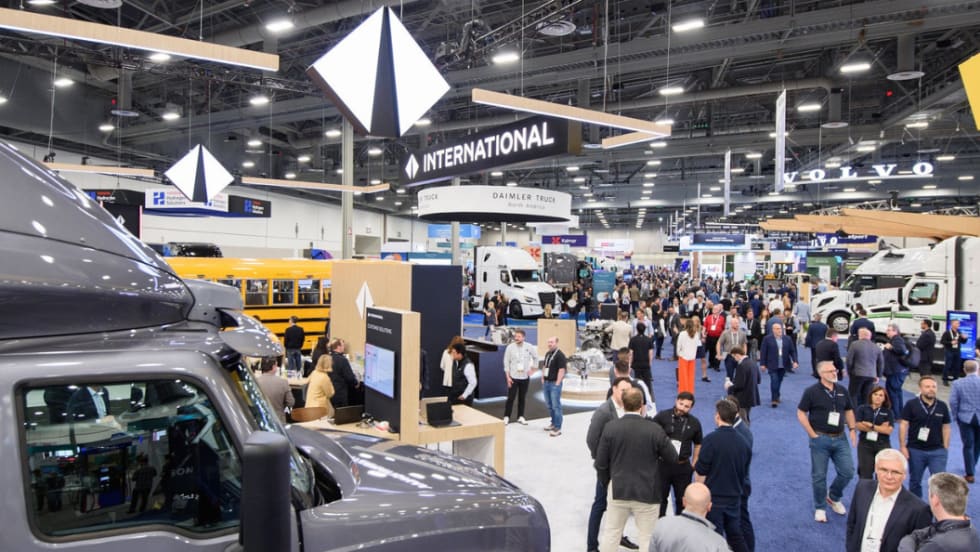 Attendees gather across the ACT Expo opening reception and exhibit hall featuring major commercial vehicle and electrification brands.