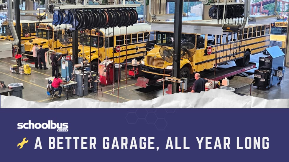 School bus maintenance garage with several yellow buses undergoing service, mechanics working in repair bays, and overhead equipment. Graphic reads “A Better Garage, All Year Long” with the School Bus Fleet logo.