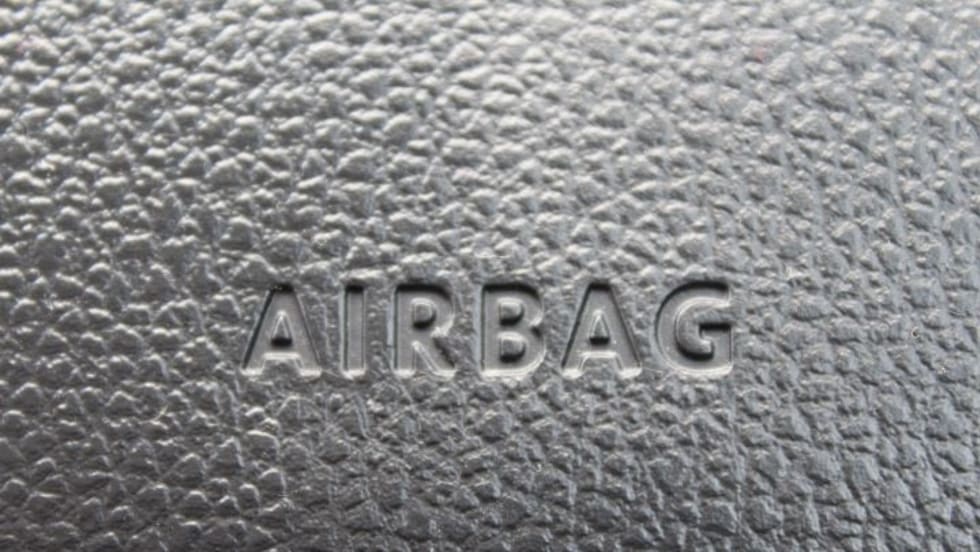 Closeup photo of 'airbag' stamp on a car dash