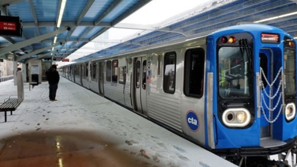 A Chicago Transit Authority 7000-series railcar at a snowy station.
