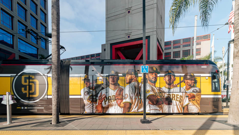 A San Diego Metropolitan Transit System trolley wrapped with a Padres player advertisement.