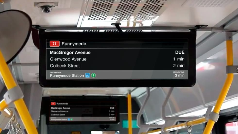 New digital signage attached to the ceiling of a TTC bus.