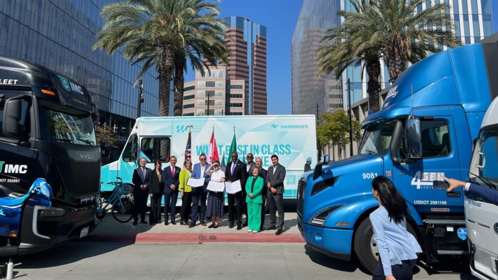Group of people and zero-emission trucks during ceremony announcing a West Coast ZEV corridor.