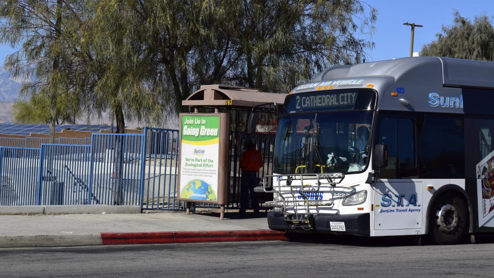 A SunLine clean air bus at a stop. 