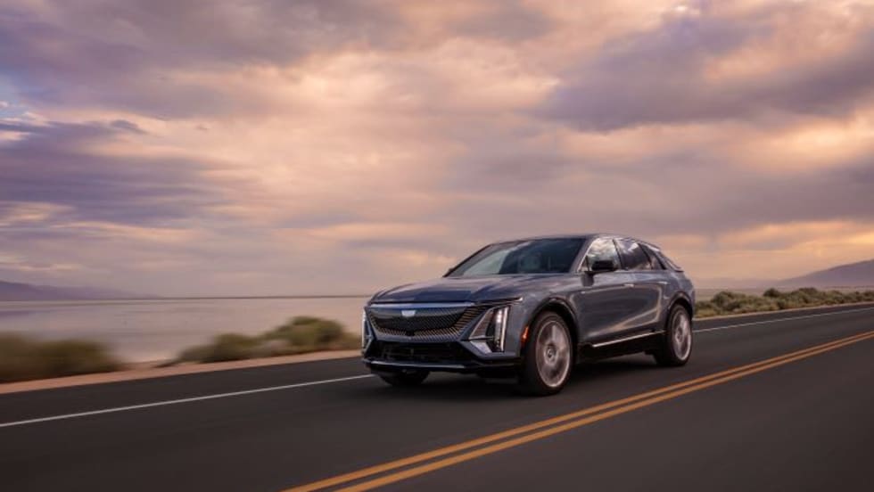 Photo of Cadillac Lyriq SUV on road with partly cloudy sky in background