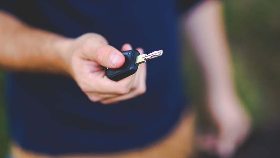 Photo of man holding a car key