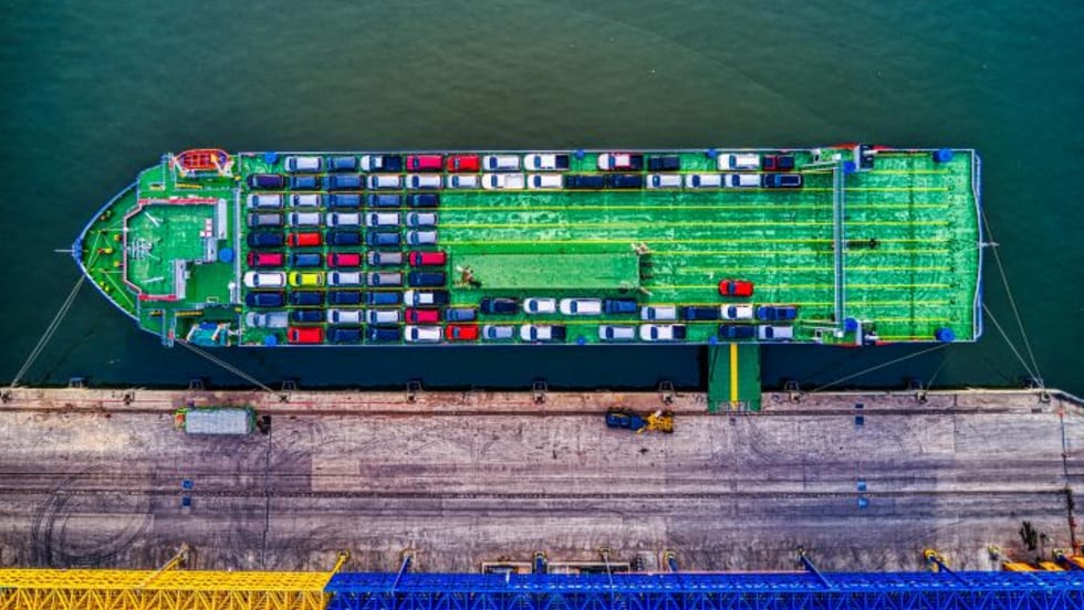 Overhead view of container cargo ship loaded with vehicles