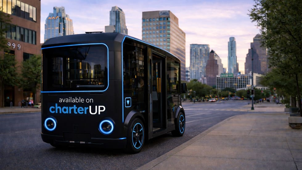 A black and blue HOLON urban autonomous vehicle on a city street.
