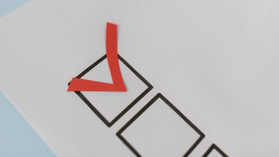 A checkbox on a sheet of paper checked in red