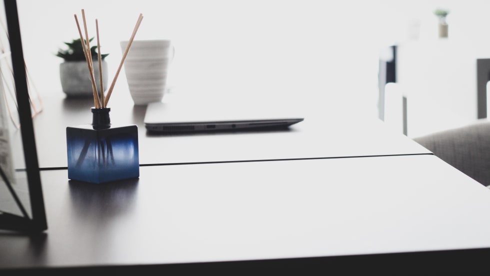 Photo of essential oil diffuser on desk next to laptop