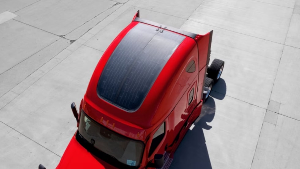 Solar panels on top of a red Class 8 truck sleeper cab