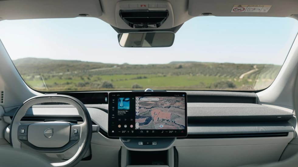 Interior dashboard view of a Volvo EV featuring Google Maps navigation and infotainment display during a demo of upcoming Gemini AI vehicle integration.