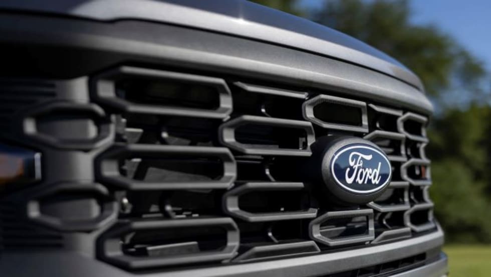 front grill of a Ford truck with blue Ford emblem
