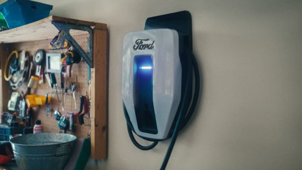 Photo of wall-mounted Ford electric-vehicle charger in a home