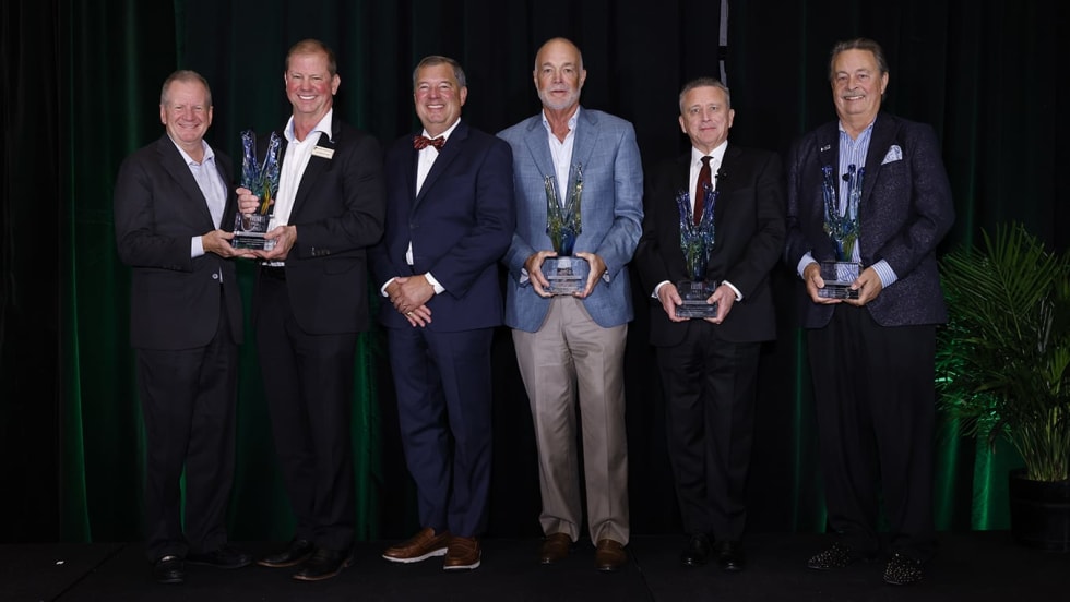 Group photo of men holding awards.