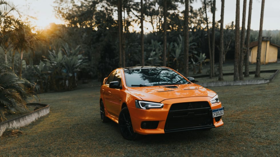 Orange Mitsubishi car on grass