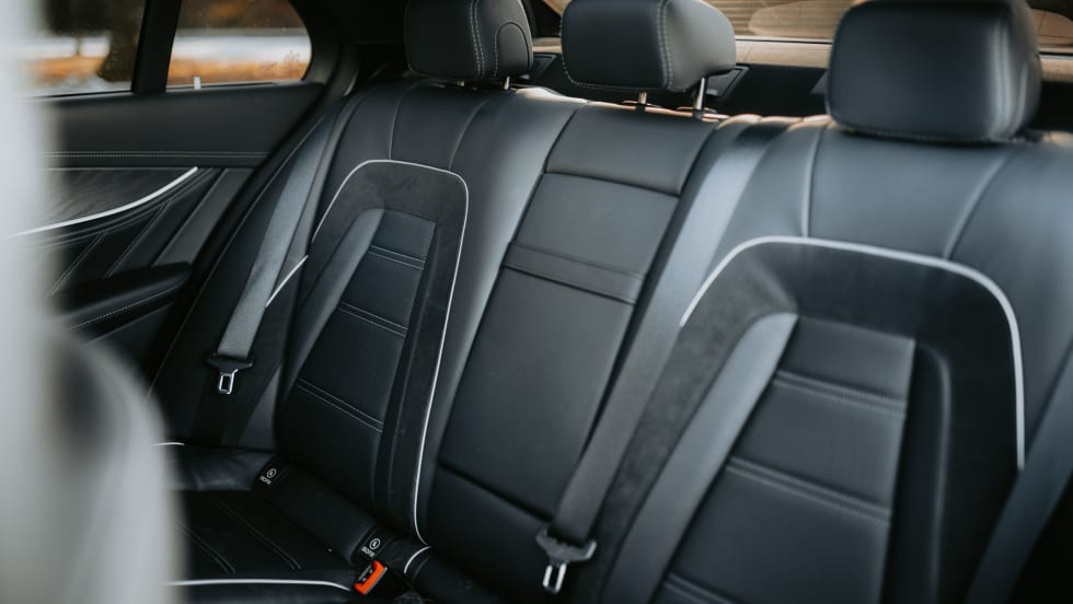Black leather with white trim back passenger seats.
