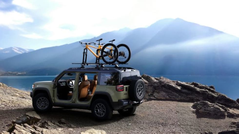 Photo of a parked Jeep Recon with a mountain peak in the background