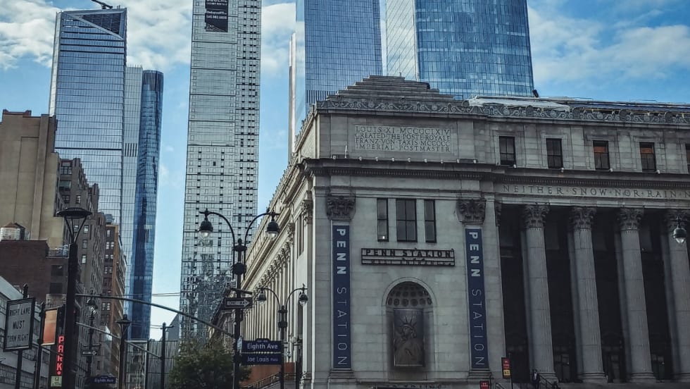 A scene of Penn Station with Hudson Yards skyscrapers in the background in New York City.