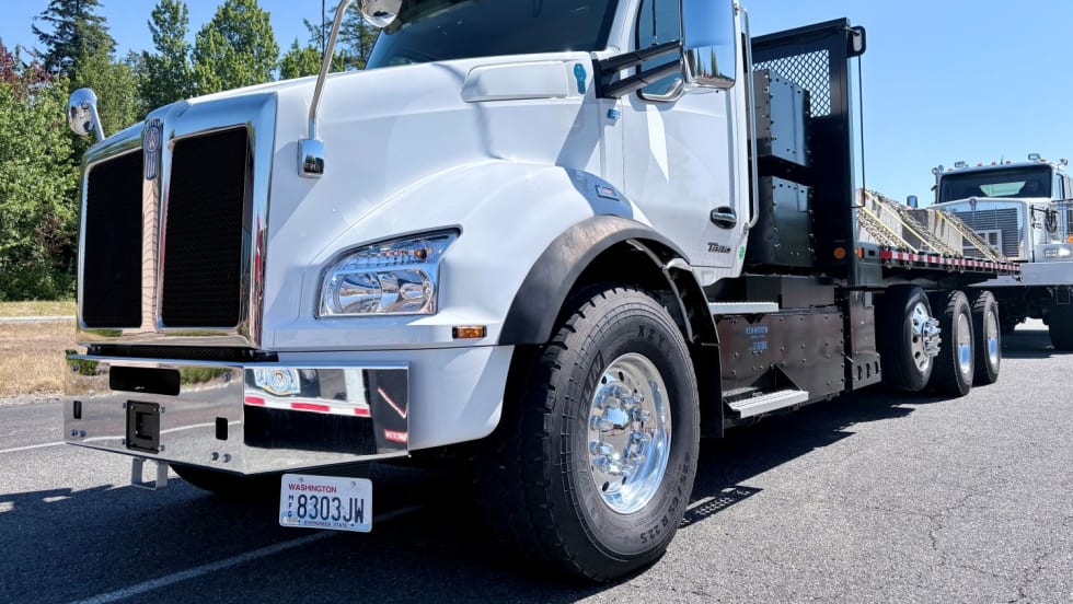 White heavy-duty Kenworth T880e battery-powered straight truck with flatbed