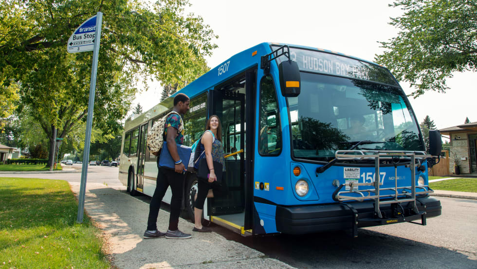 Passenger boarding Saskatoon Transit bus.