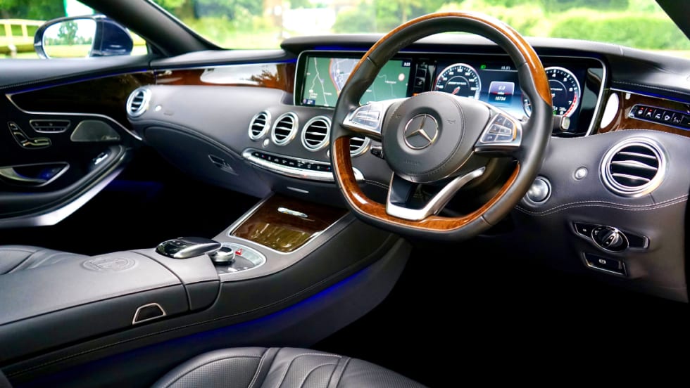 interior view of car dashboard and steering column. gray interior