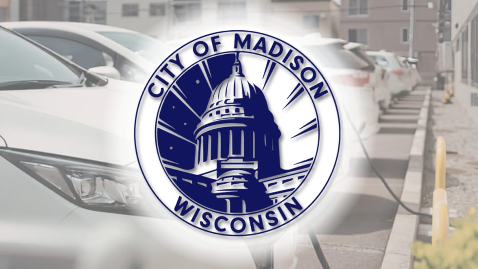 City of Madison, Wisconsin seal overlaid on an image of electric vehicles parked and charging in a row.
