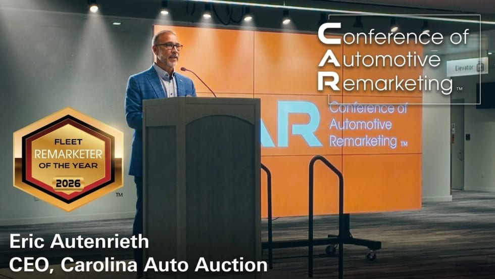 Eric Autenrieth accepts the Fleet Remarketer of the Year award on a stage at the CAR Conference in Cleveland, OH.