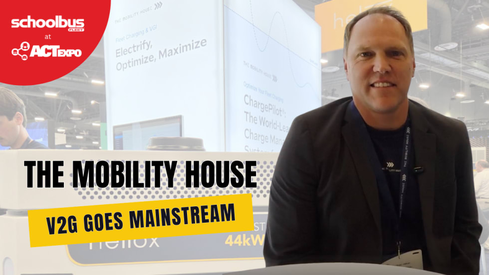 Russell Vare of The Mobility House sits at the company’s ACT Expo booth discussing vehicle-to-grid technology and smart EV charging for school bus fleets. Overlay text reads “V2G Goes Mainstream” alongside School Bus Fleet at ACT Expo branding.