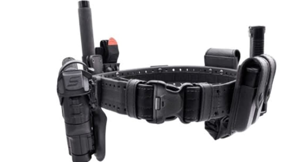 A close up of a police holster with assorted pockets for officers' equipment.