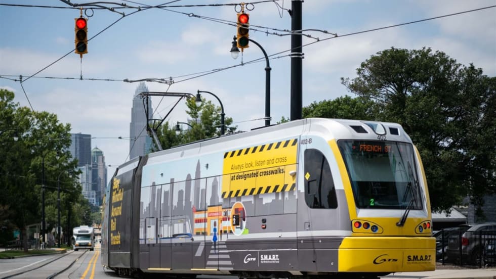 The CATS Gold Line in service with the city skyline in the background.