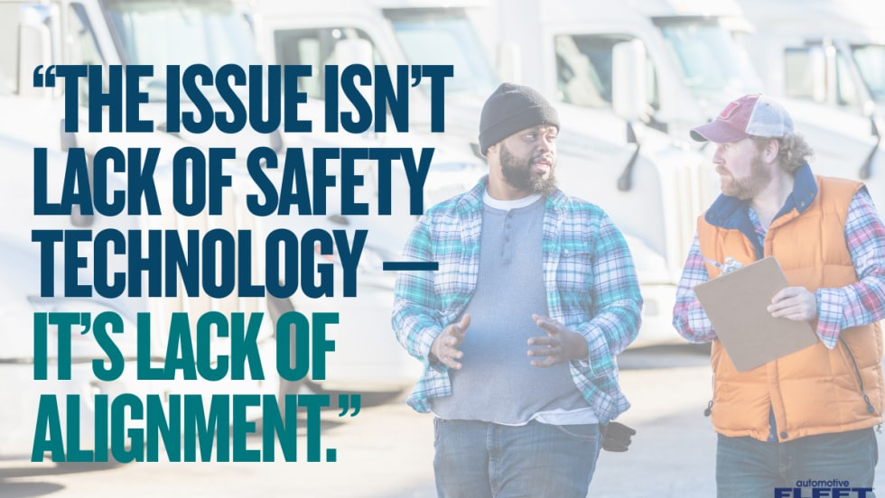 Two trucking industry workers talk in front of semi-trucks beside text reading, “The issue isn’t lack of safety technology — it’s lack of alignment.”