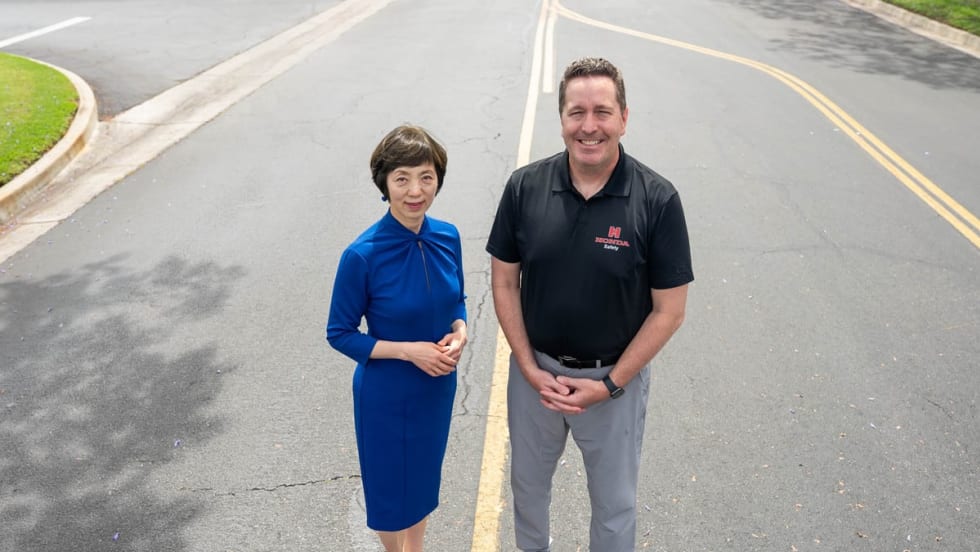 Sue Bai and Brian Bautsch standing on a road