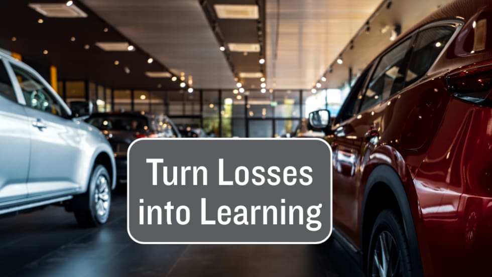 inside car dealership, text box Turn Losses into Learning, Auto Dealer Today