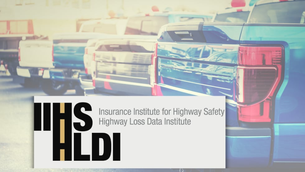IIHS HLDI text overlaid on the trunks of pick up trucks.